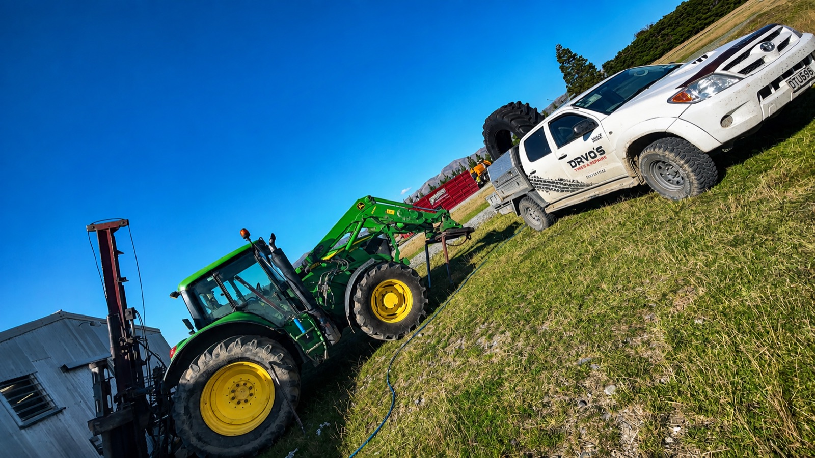 The Davo's ute beside a John Deere tractor on an on-farm call-out